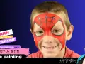 Un niño sonriente con un increíble spiderman dibujo cara. Aprende a pintar caras rápido y divertido.