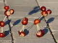 Figuras hechas con castañas y palillos, una divertida manualidad castaña que parece una molécula o un robot.