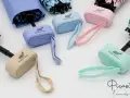 Paraguas personalizados para profesores, en colores pastel y con el logo de Grupo Coelca.