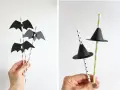 Decoración Halloween manualidades: pajitas con murciélagos de papel negro y sombreros de bruja.