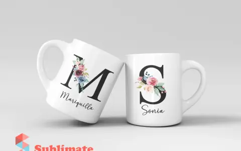 Dos tazas blancas con iniciales decoradas con flores. Una tiene la "M" de Mariquilla, la otra la "S" de Sonia.