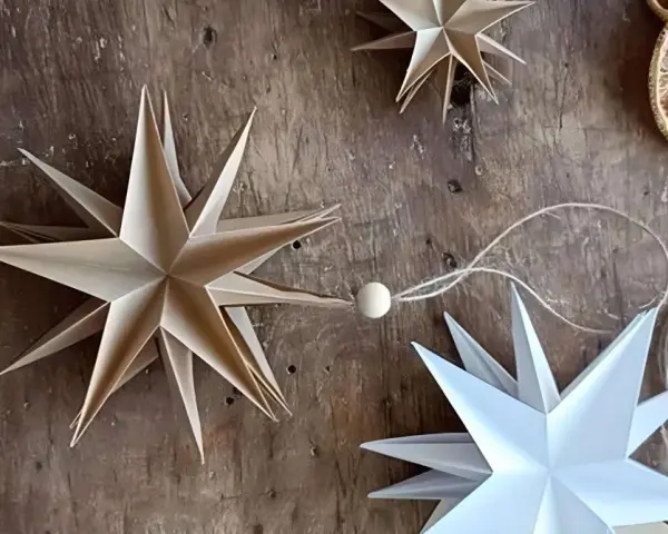Estrellas de papel hechas a mano, perfectas manualidades adornos navideños caseros. Decoración rústica con rodajas de naranja seca.