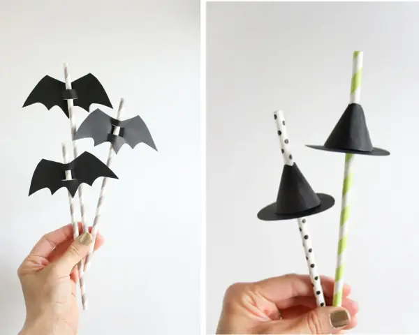 Decoración Halloween manualidades: pajitas con murciélagos de papel negro y sombreros de bruja.